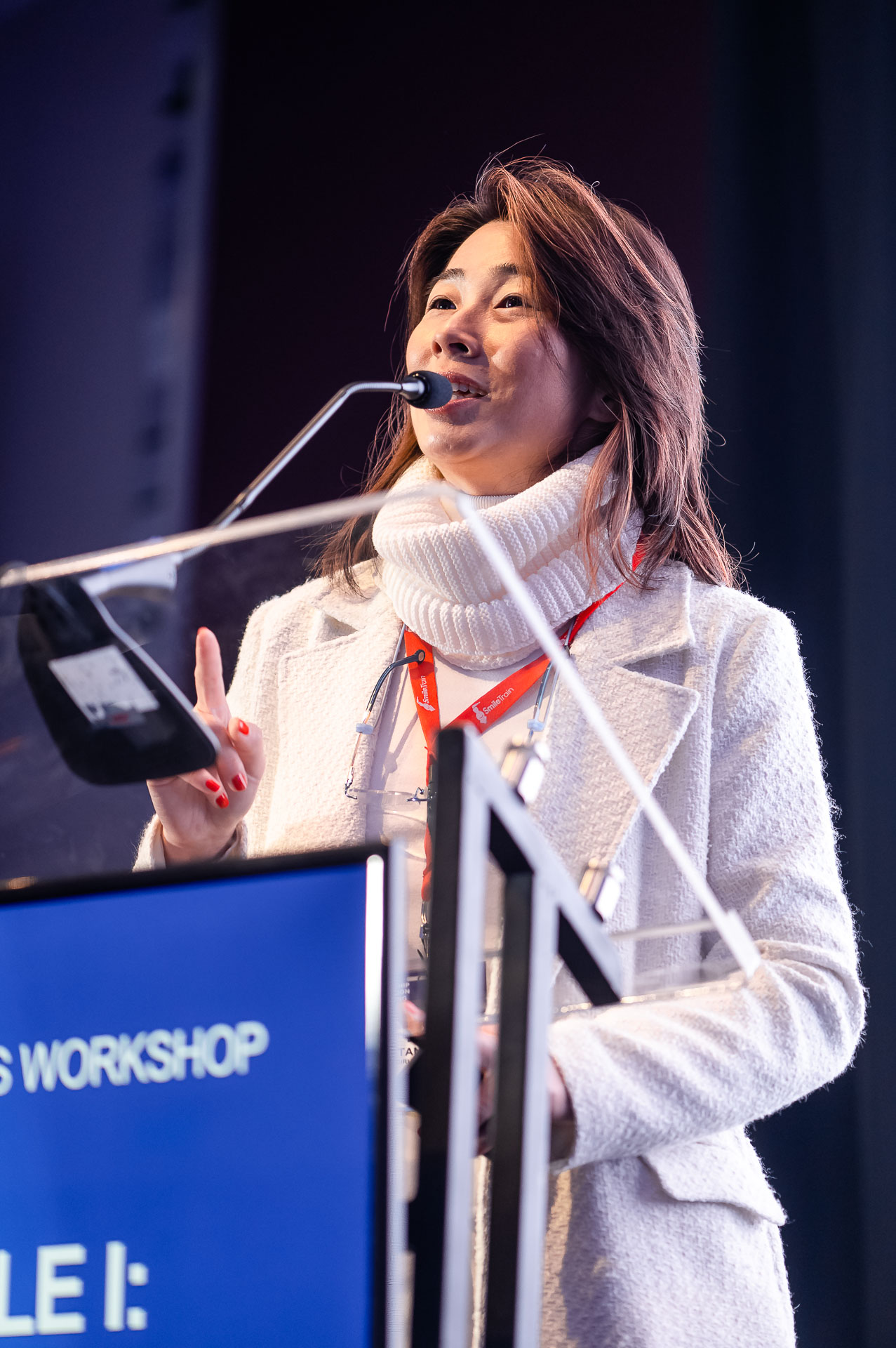 Dr. Daniela Tanikawa speaking at a podium