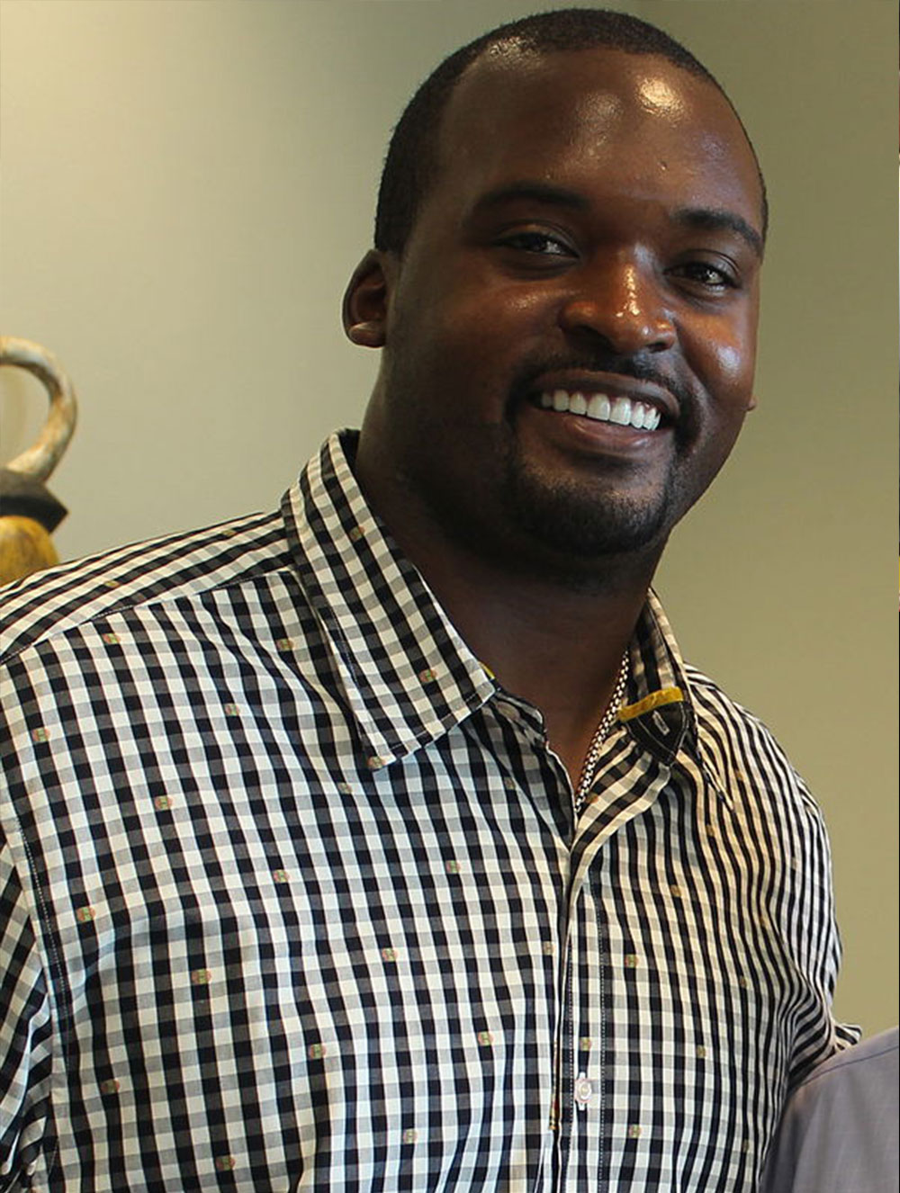 Mathias Kiwanuka in a plaid shirt