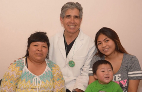 Dr. Luis Cuadros with a cleft lip and palate patient and his family on a New Mexico Navajo reservation.
