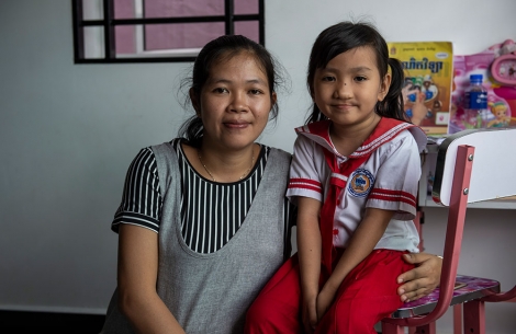 A school-aged Meng with her mother after cleft lip and cleft palate surgery in Cambodia