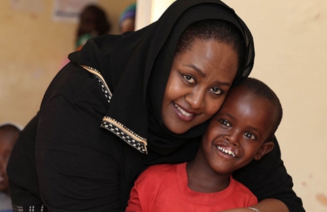 Sesnie hugging a boy after cleft lip and cleft palate surgery in Ethiopia