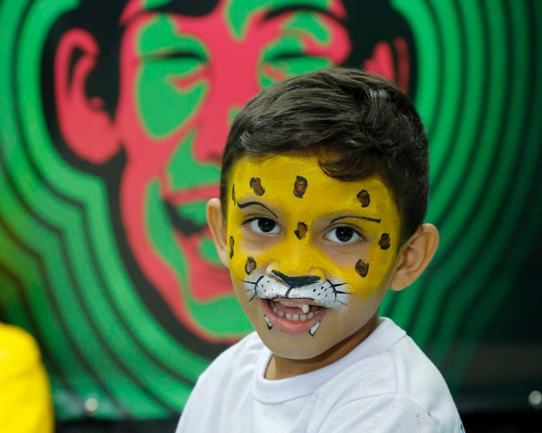 A child smiling with facepaint on