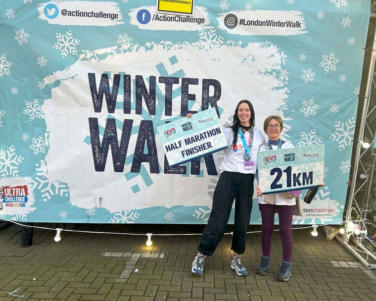 Emily Stott and her mother smiling and holding medals at the Winter Walk half-marathon