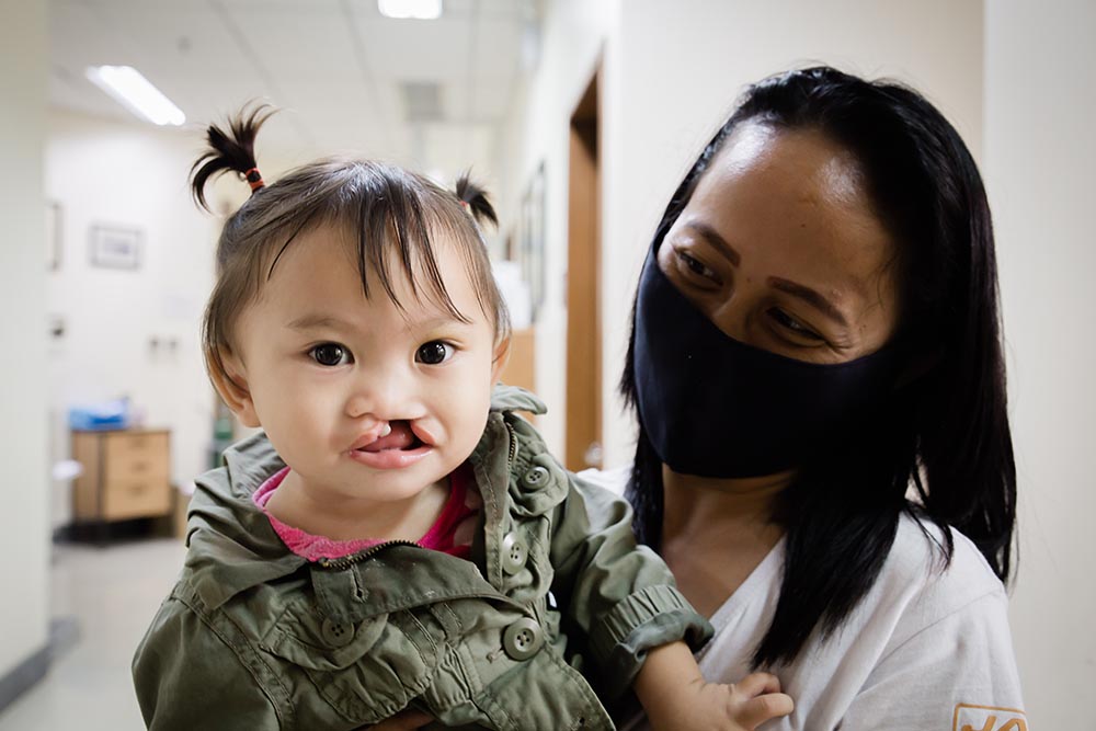 Andre held by mother getting ready for cleft surgery