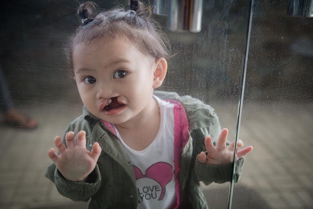 Andrea presses against a glass door