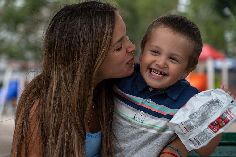Celeste kisses her son, who has a big smile