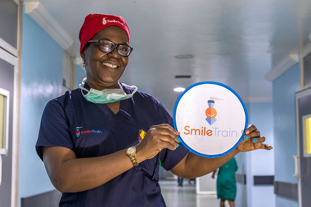 A Smile Train partner at LUTH holds a Smile Train logo