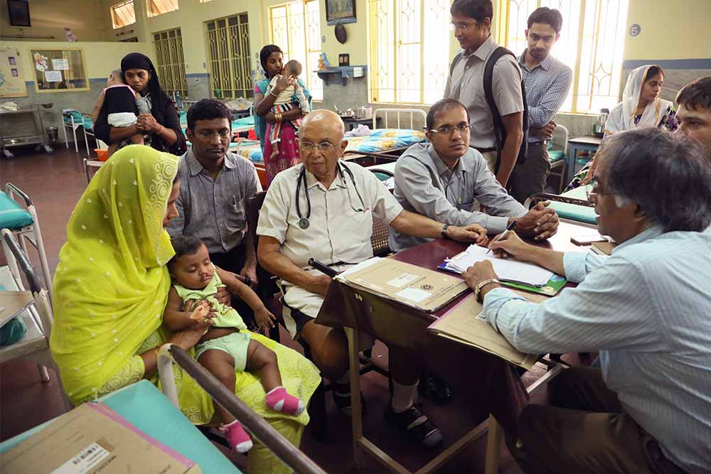 Dr Adenwalla with a large group of doctors and patients