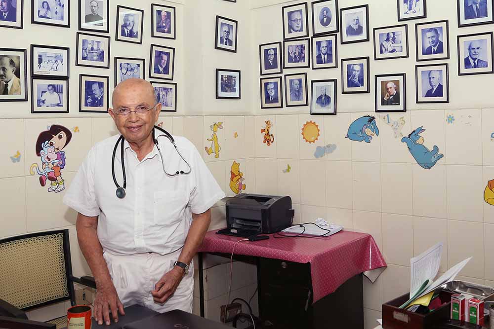 Dr Adenwalla in his office full of images of surgeons