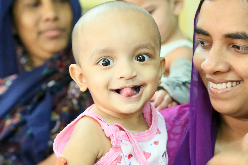 A patient of Dr Adenwalla smiles at camera