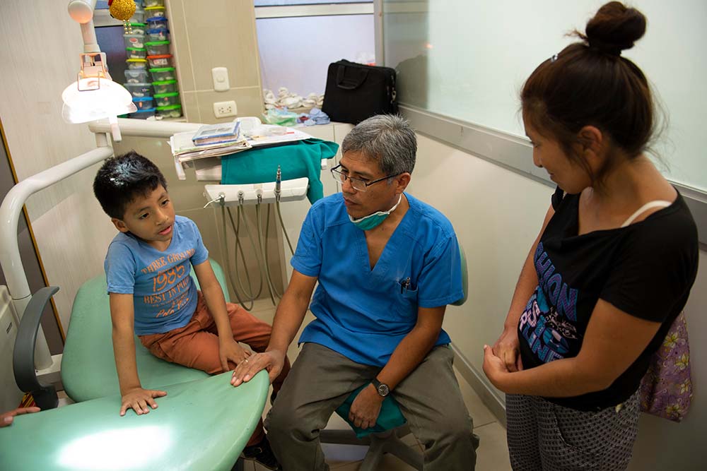 Dr Meza give advice to dental patient