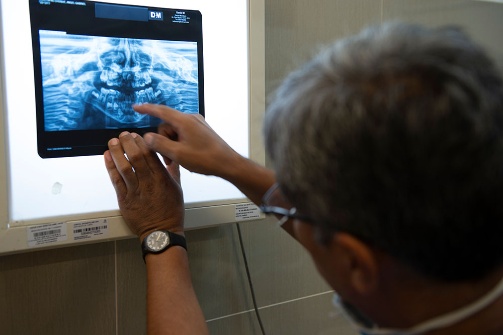 Dr Meza points at a dental xray