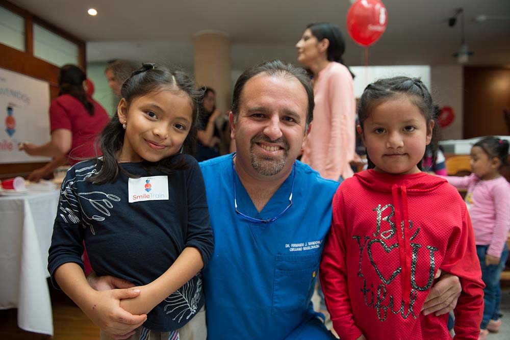 Dr Sandoval Jr with two cleft patients