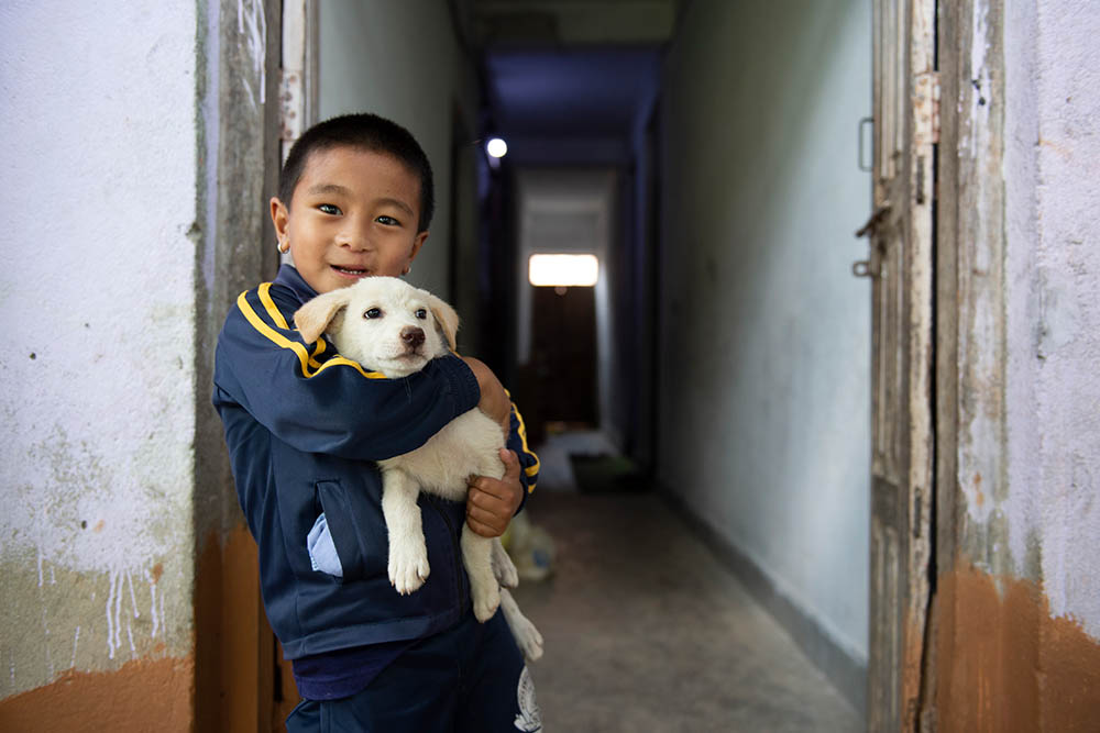 Jenious holding his dog