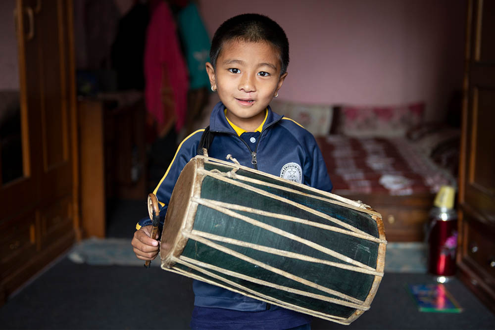 Jenious holding his drum