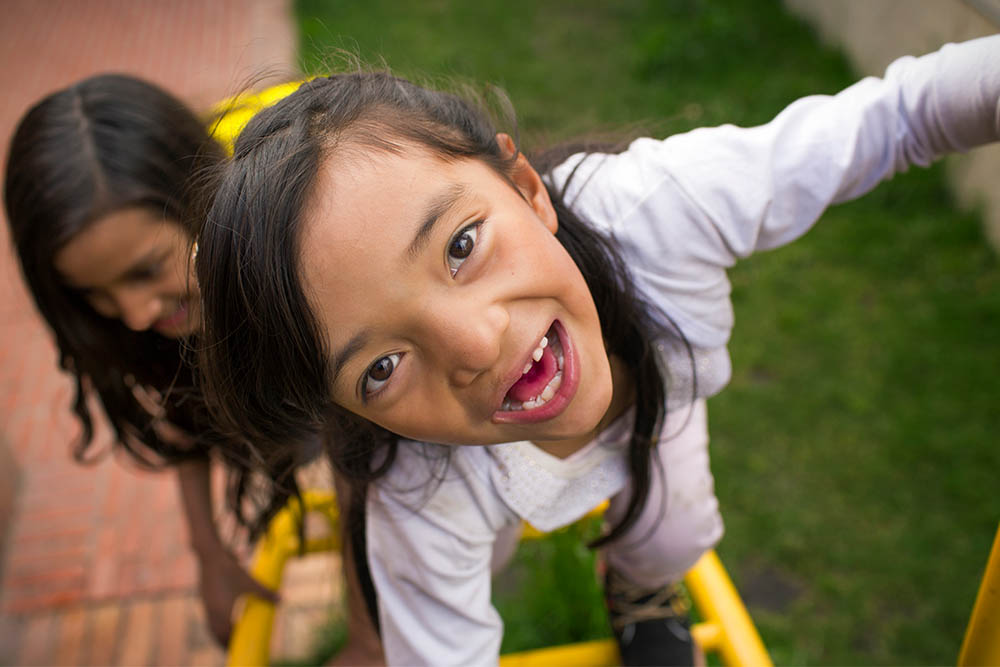 Maria playing with a friend on the playground