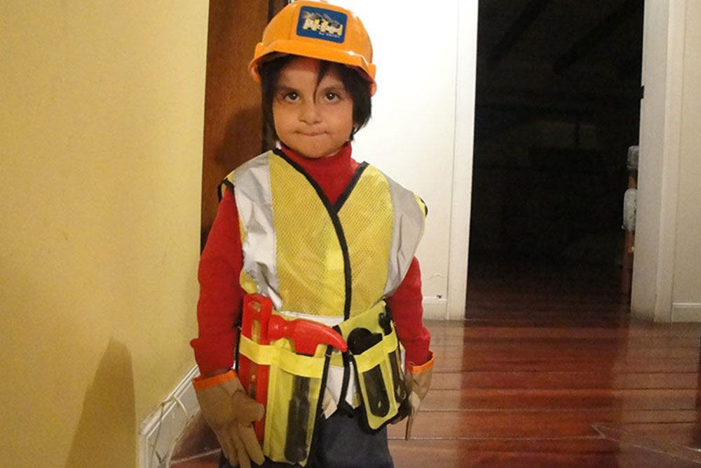 Cris' son wearing builder uniform