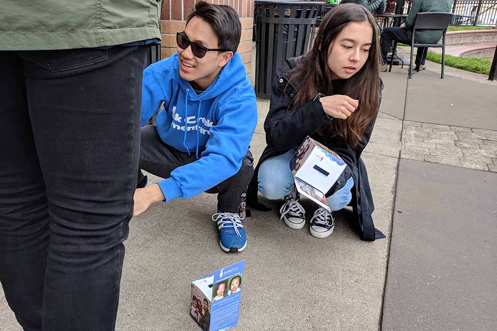 Michael with a donation box on the ground