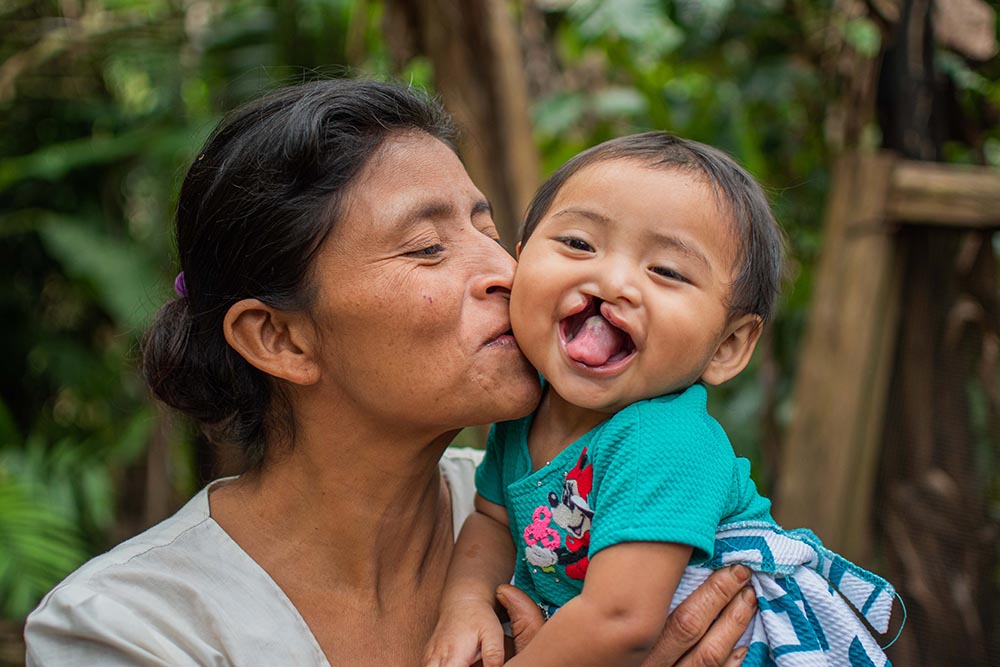 Mirian gets a kiss on the cheek from mom