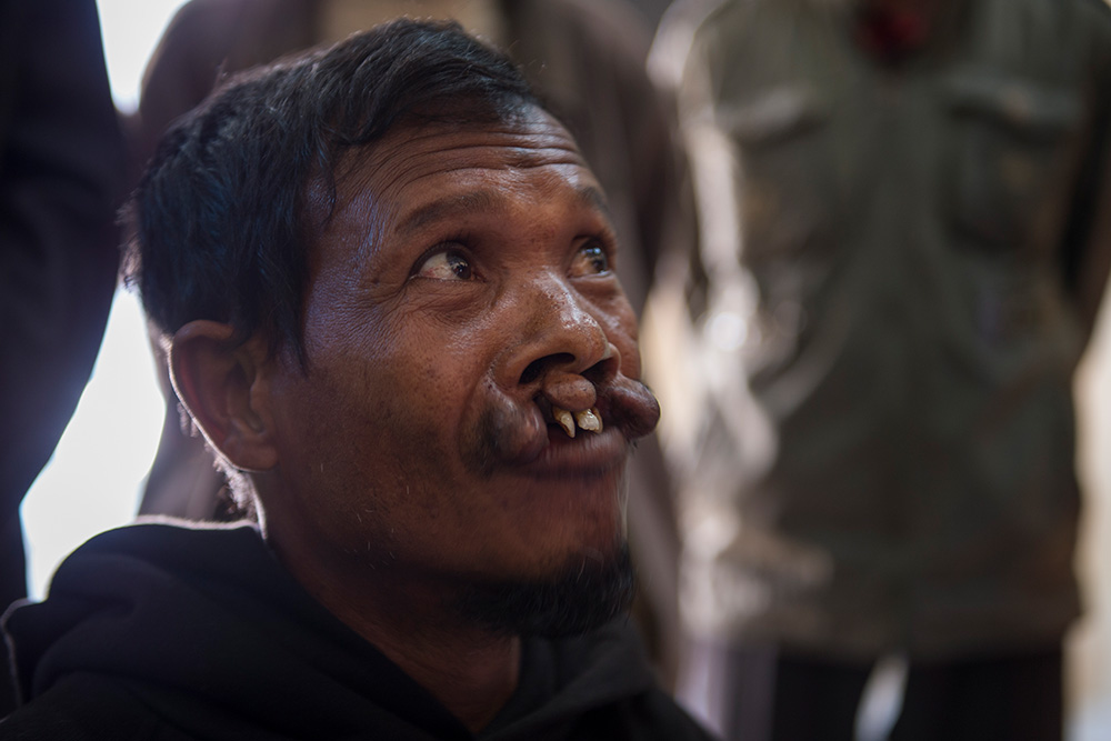 Mohammad in a group of people at refugee camp