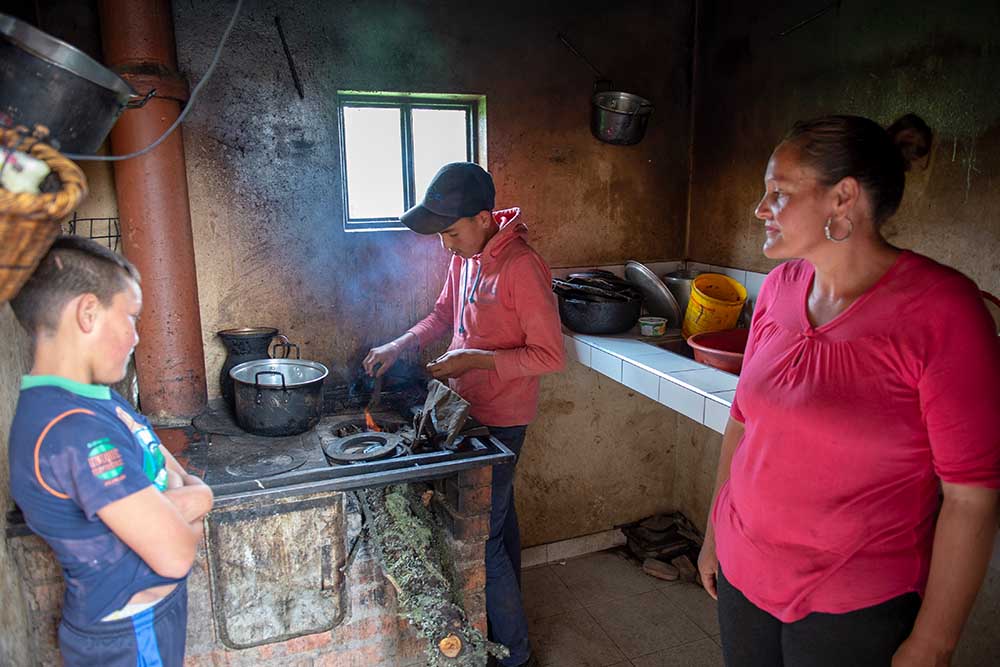 Neitan watches his brother cook over fire