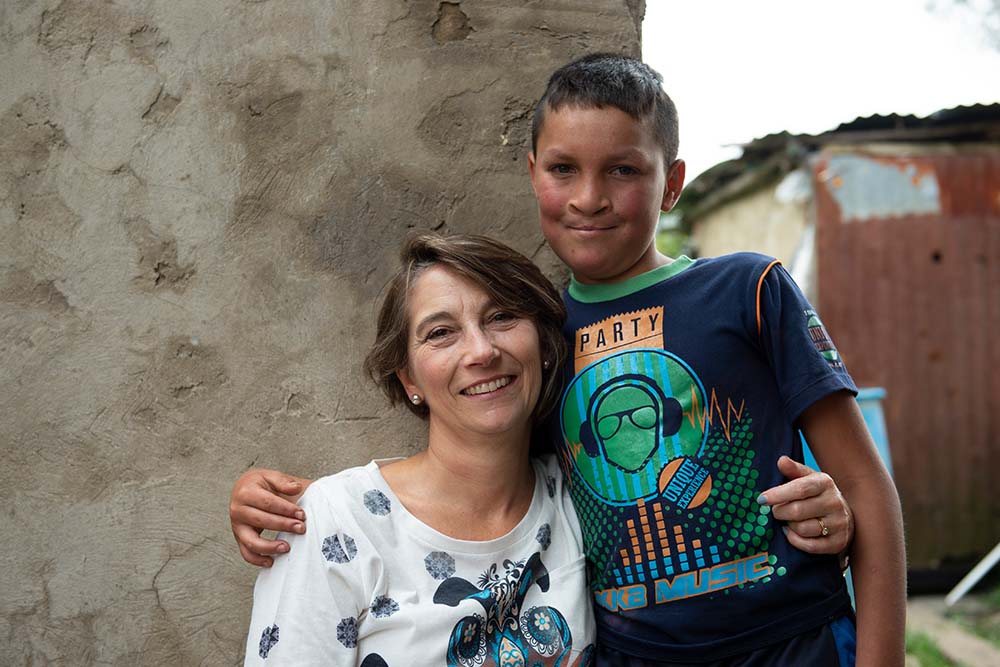 Pilar stands next to her cleft speech patient Neitan