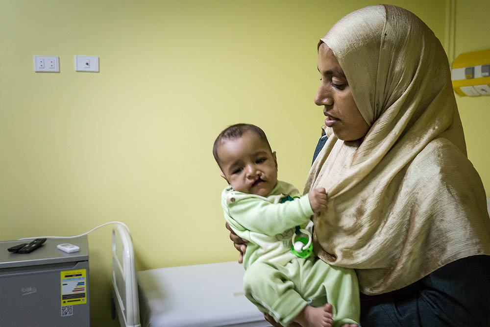 Rawda in her mother's arms before cleft surgery