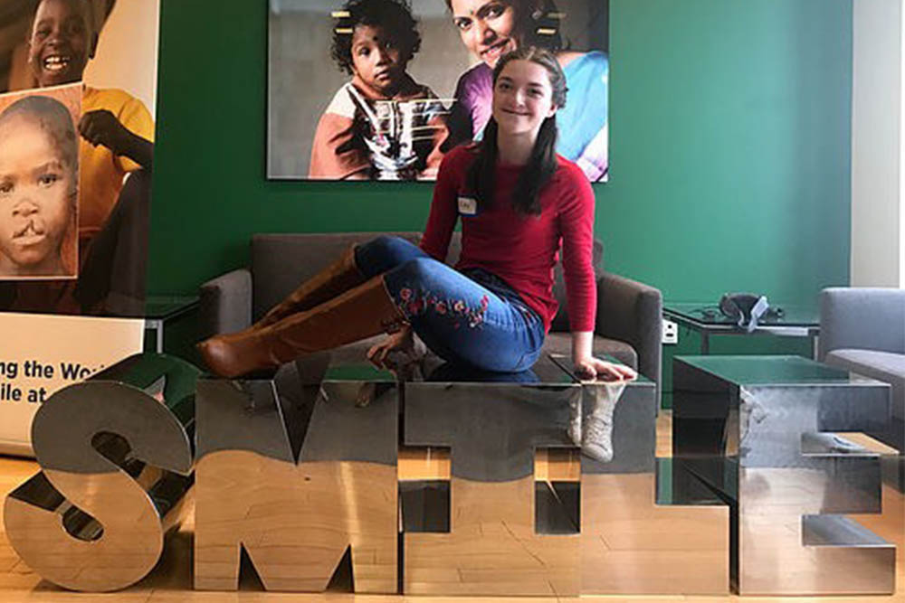 Riley on a coffee table that says smile