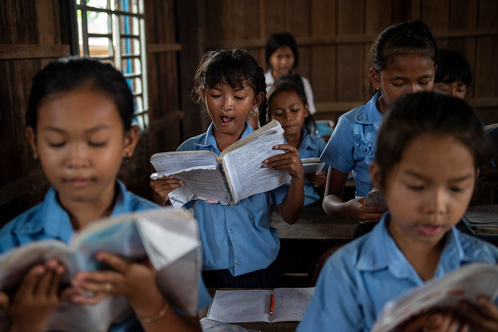 Samnang reading out loud with her classmates