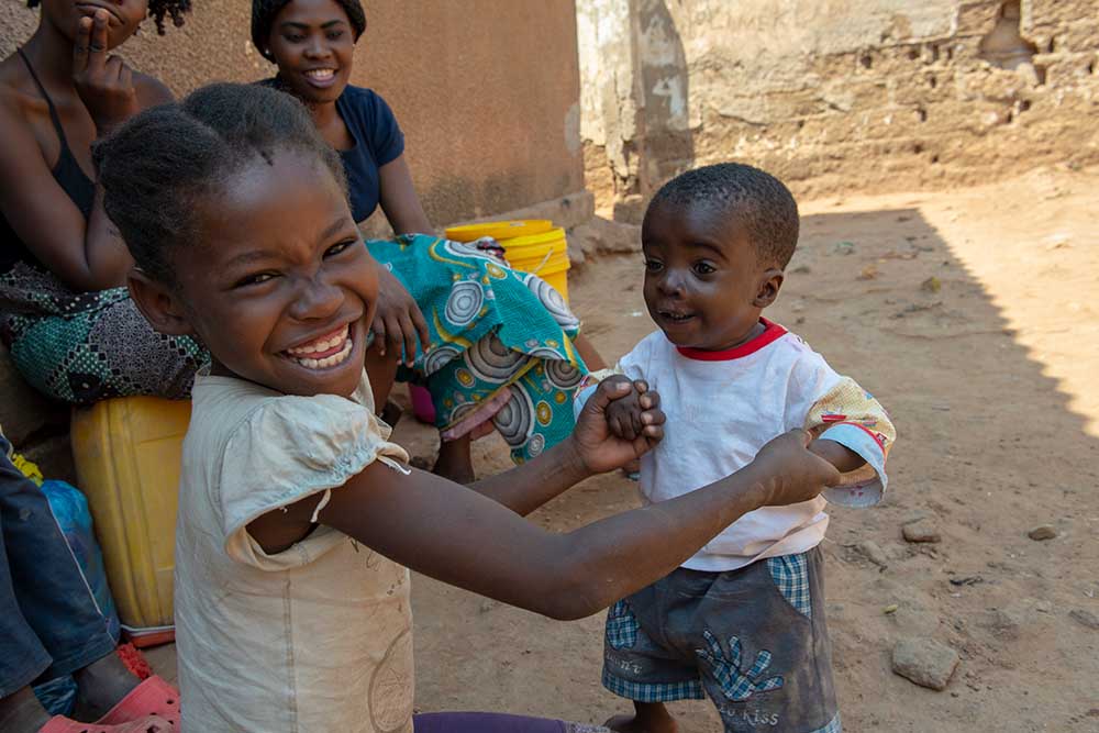 Samson dances with his sister and both laugh