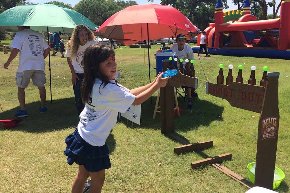 Child plays ring toss at SmileFest