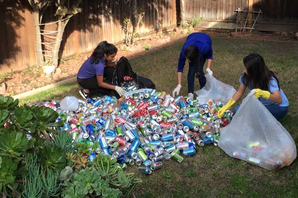 Sonali picking up cans to recycle for money