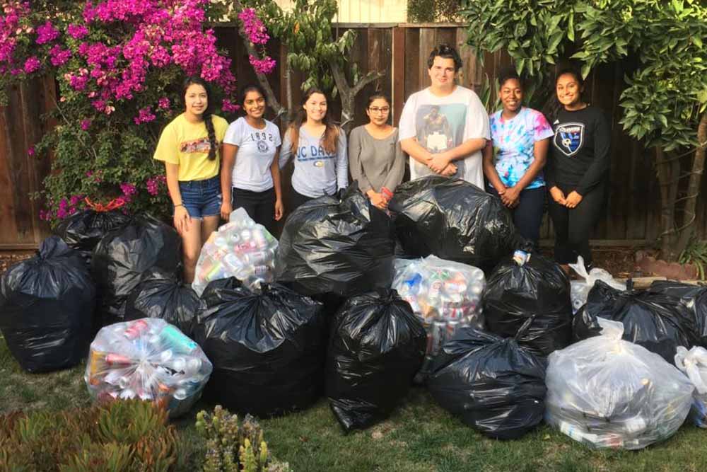 Sonali in front of large group of bags