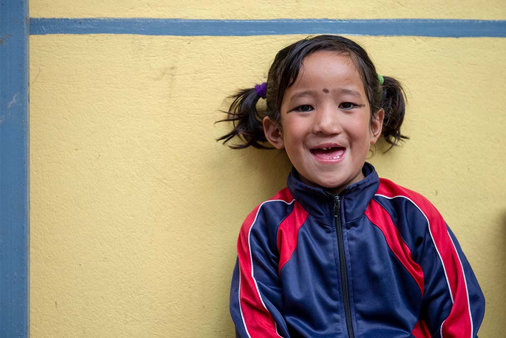 Sushila smiles in school uniform