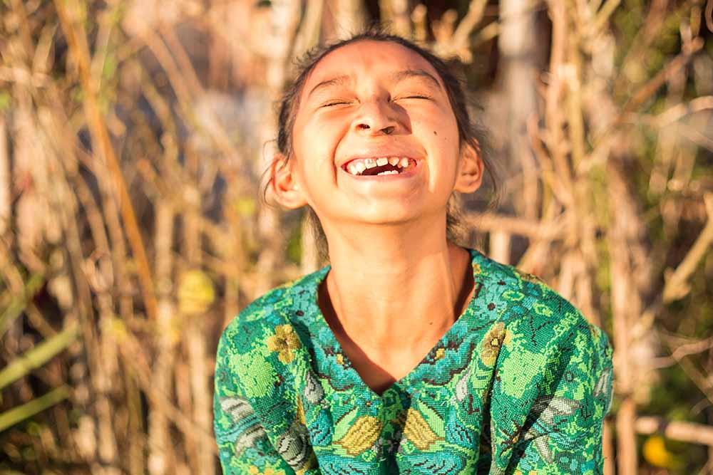 Valery laughing in field