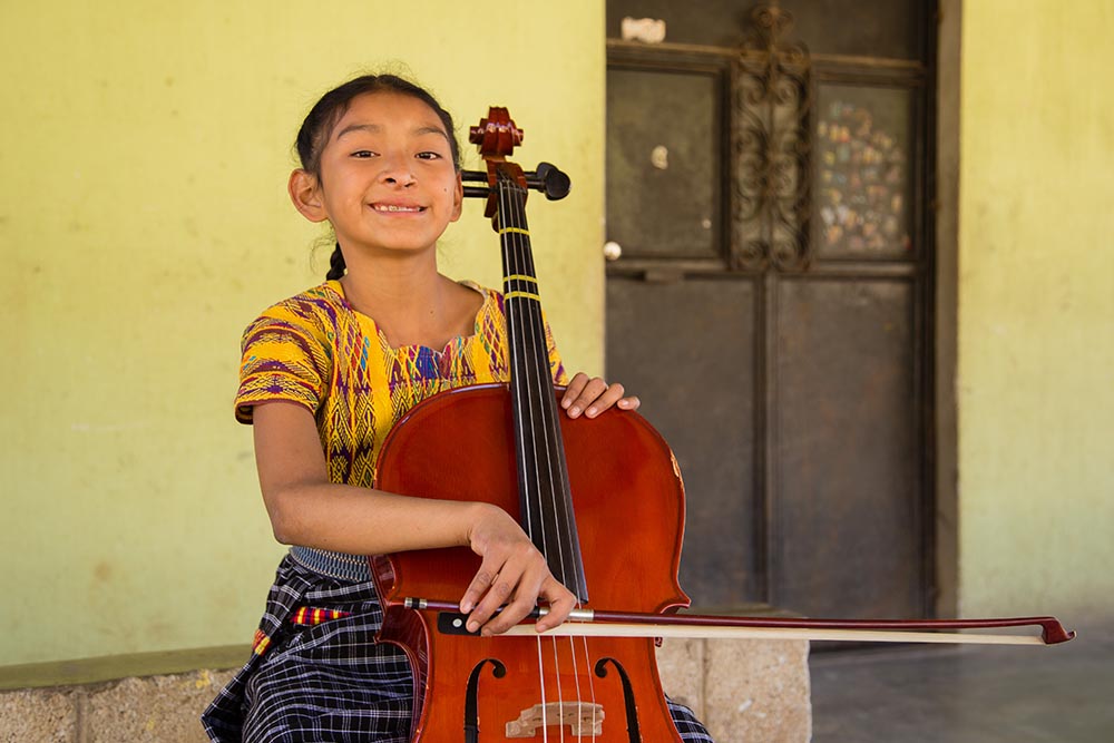 Valery sits with her cello 