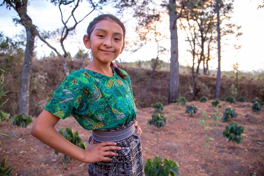 Valery smiles with hand on hip