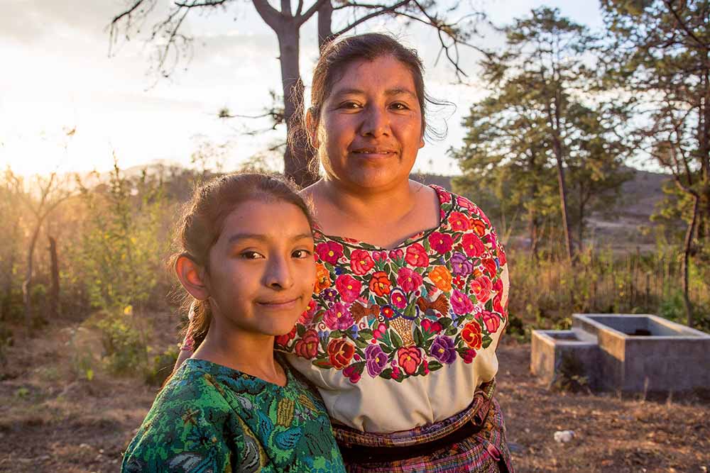 Valery stands next to her mother