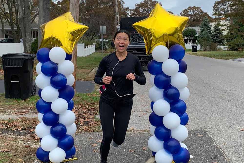 Margaret crosses a finish line for her own race