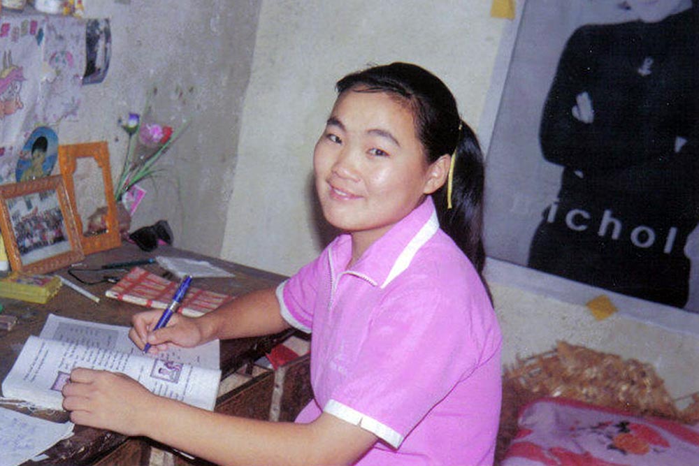 Wang Li after cleft surgery studying at her desk