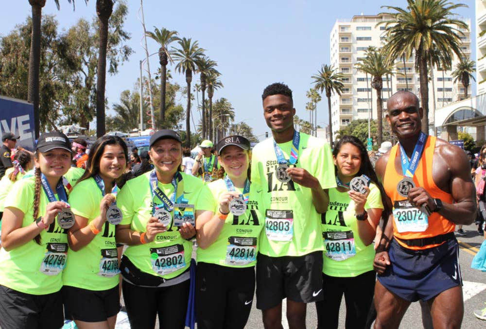 Dr Lawrence poses with a group of marathon finishers