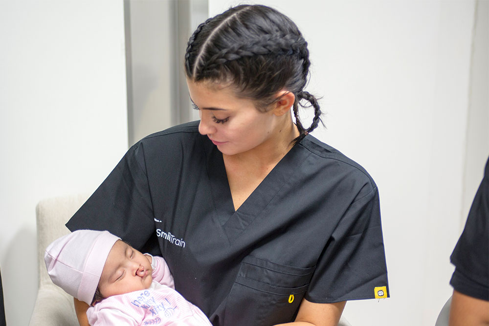 Kylie Jenner holds a baby with a cleft at the hospital