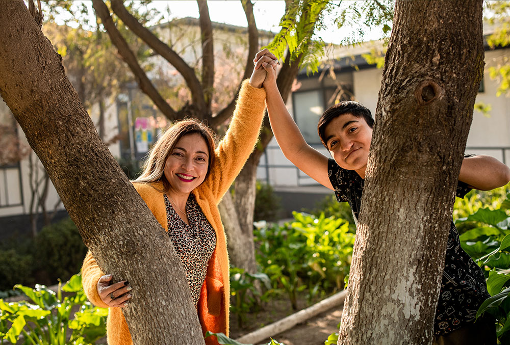 Vicente and his mother holding hands in trees