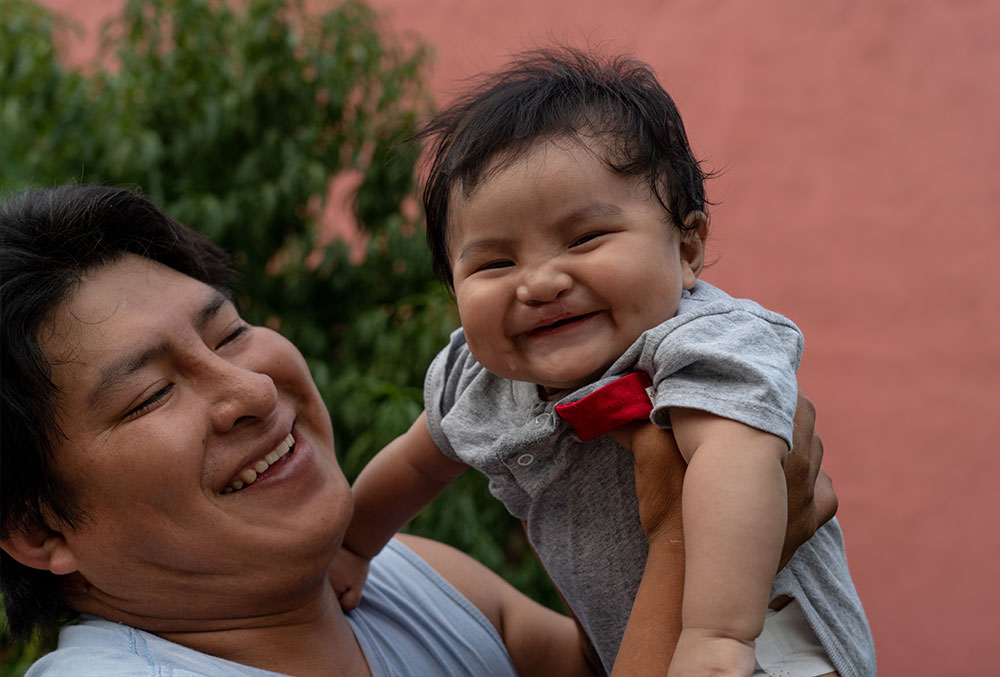 Jose and Miguel smiling widely together after Miguel's cleft surgery