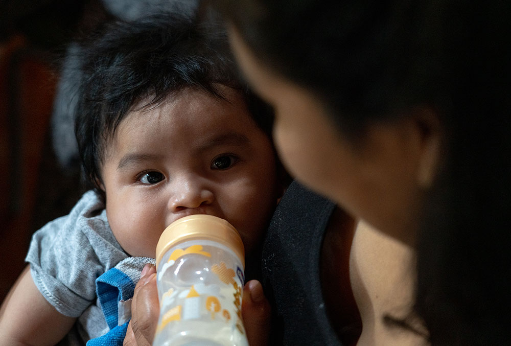 Miguel feeding with a special bottle