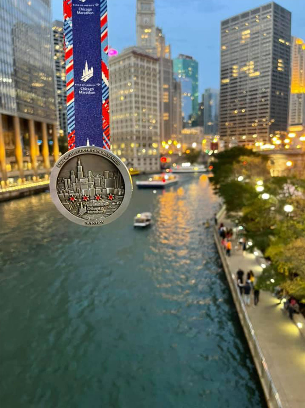 Eddie dangles his medal over the Chicago River