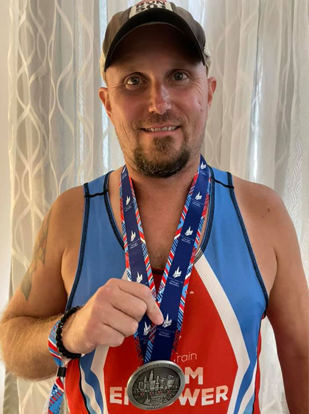 Eddie in his Team EMPOWER singlet with his medal for completing the Chicago Marathon