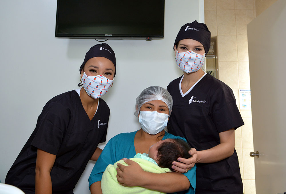 Miss USA and Miss Peru with a patient and their mother right after cleft surgery