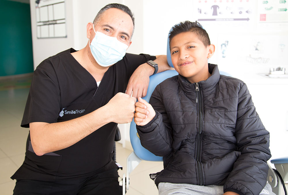 Alex pounds fists with his dentist