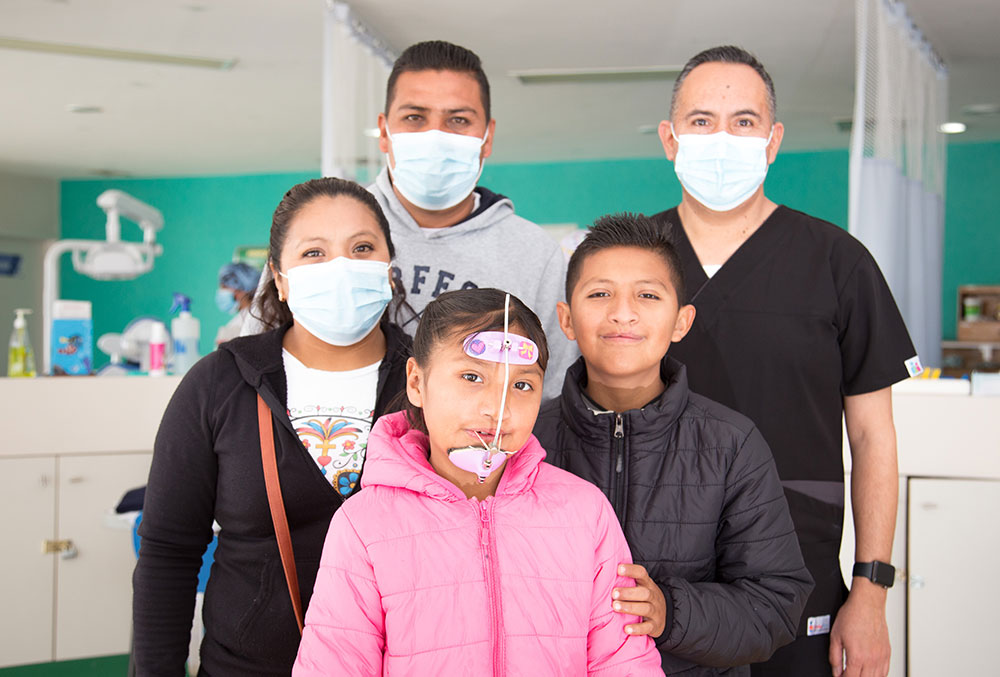 Alex, Kendra, their parents, and a member of their cleft team